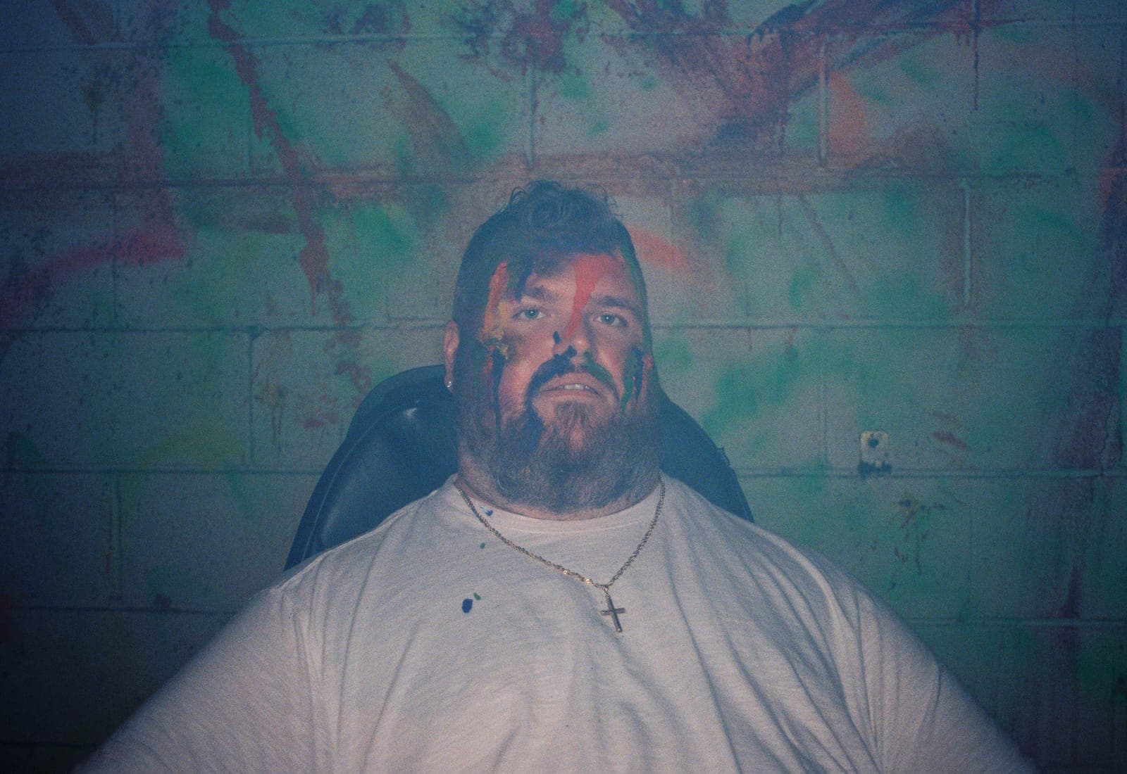 Portrait of a bearded man lit in teal light